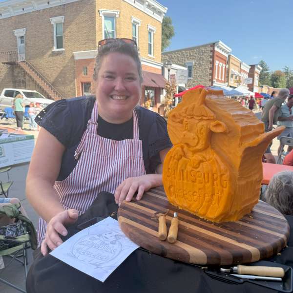 Photo of Vicki Poses with Carving